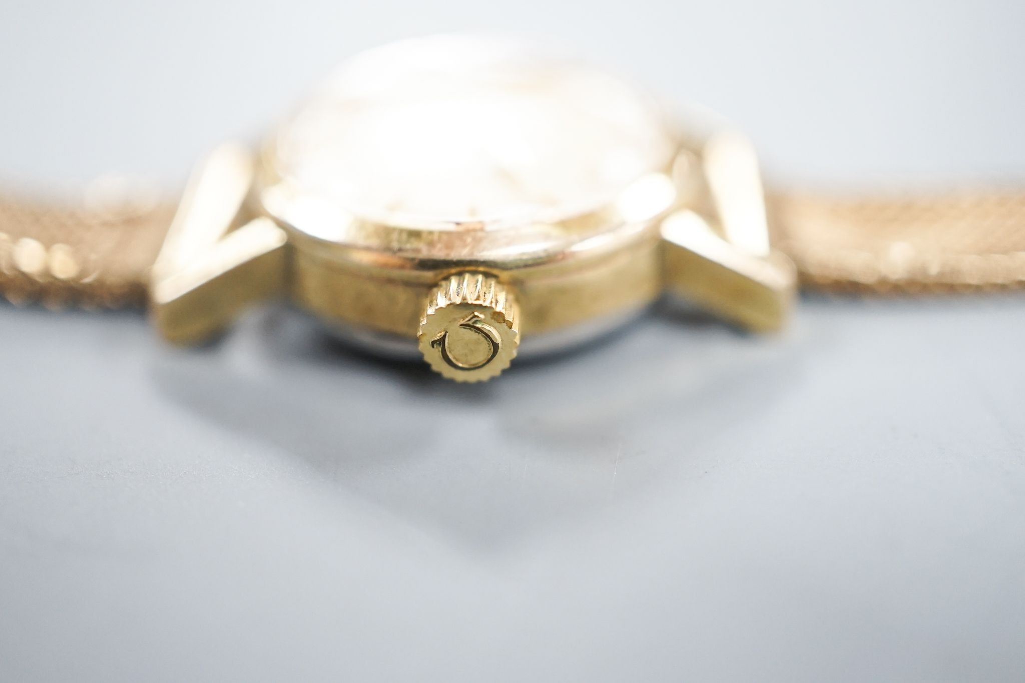 A lady's 1960's steel and gold plated Omega manual wind wrist watch, on an associated 9ct gold bracelet